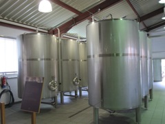 Stainless aging tanks, which are less of a good thing.  Wood casks, preferably aged oak used to store Sherry are best.