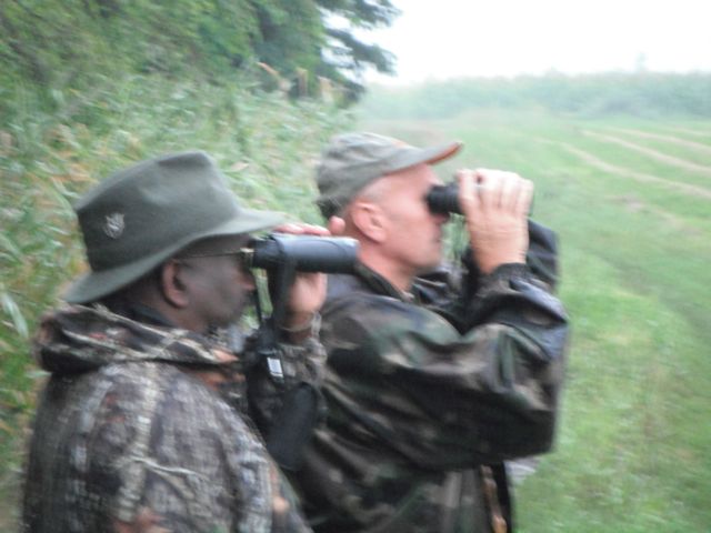 Robert Mann and our guide spot a nice buck about to lay down in the field near some corn