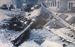 Wartime photo of a Panther Tank.  I think it broke through the street into the sewers or the like, based on the way the rails are coming up over the hull