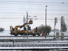 Fixing the 10,000 Volt power lines that supply the trains with power.