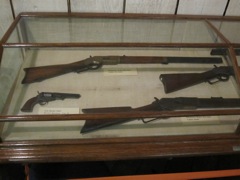 Winchester 1873 and 1886 rifles and a Colt Revolver